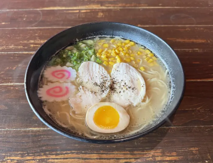 Chicken Ramen - Noodles in a rich chicken soup, topped with sliced chicken, corn, and green onions at Ramen Jin, a Ramen restaurant in Houston