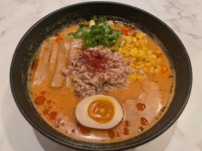 Spicy Miso Ramen - Spicy miso - based broth ramen with minced meat, corn, and half - boiled egg at Ramen Jin, a Ramen restaurant in Houston