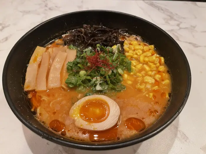 Spicy Tantanmen Ramen - Spicy ramen with minced meat, bamboo shoots, corn, and half - boiled egg at Ramen Jin, a Ramen restaurant in Houston