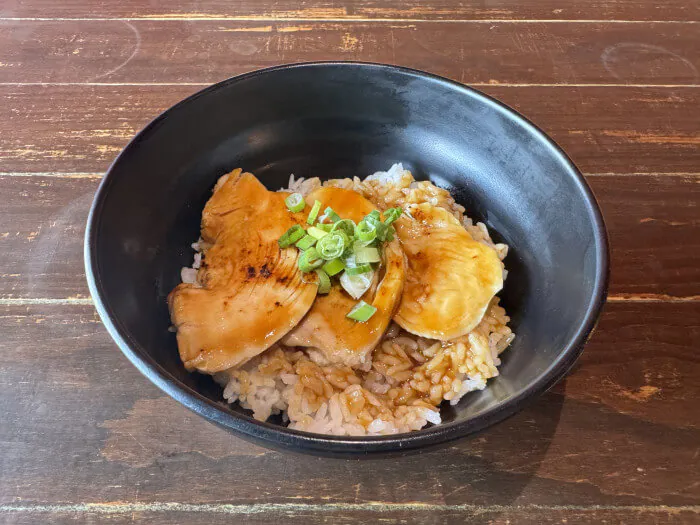 Chicken Donburi - Grilled chicken slices served over seasoned rice, garnished with green onions at Ramen Jin, a Ramen restaurant in Houston