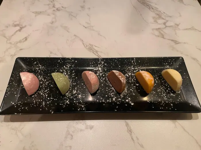 A variety of flavored mochi desserts neatly arranged on a plate at Ramen Jin, a Ramen Restaurant in Houston